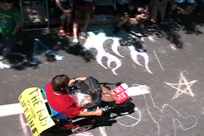 Chuck wheels over sidewalk chalk in parade