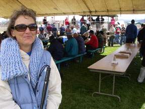 nancie stands in front of chow line full of vets